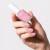 Dłoń z paznokciami pomalowanymi lakierem Yokaba 03 Sweet Pink i butelka lakieru