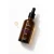 Butelka olejku Yokaba Black Orchid with Pink Pepper 50 ml leżąca obok kropel olejku