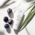 Tuba kremu Yokaba Aloe&Plum 75 ml wśród dojrzałych śliwek, obok liść aloesu