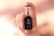 Paznokcie wykonane akrylożelem Victoria Vynn Liquid Poly Gel 02 Sugar Cloud, dłoń z butelką 15 ml