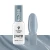 Victoria Vynn Pure Vegan Creamy Hybrid nr 286 Blue Silence 8 ml, butelka obok paznokietnika z niebieskoszarym lakierem