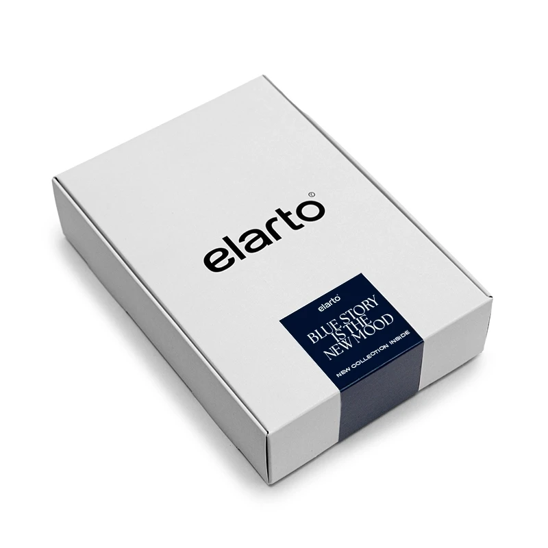 Elarto Zestaw 4 lakierów hybrydowych Lacogel Blue Story odcienie niebieskiego 4x7ml - białe pudełko elarto z granatową opaską Blue Story